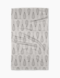 The Rosa Kichline Kitchen Whisks tea towel features a repeating pattern of black whisk line drawings on white, arranged in neat rows. Made from recycled materials, it has a subtle texture and is displayed on a plain white background.