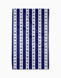 The Liberty Lines Tea Towel by Geometry features Geoweave™ fabric with vertical navy and white stripes; each white stripe has a row of navy stars. The pattern alternates between solid stripes and star-embellished sections.