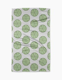 Lime Doodles by Letters By Shells is a quick-drying tea towel with a repeating pattern of green lime slices, each with visible segments, arranged in neat, evenly spaced rows.