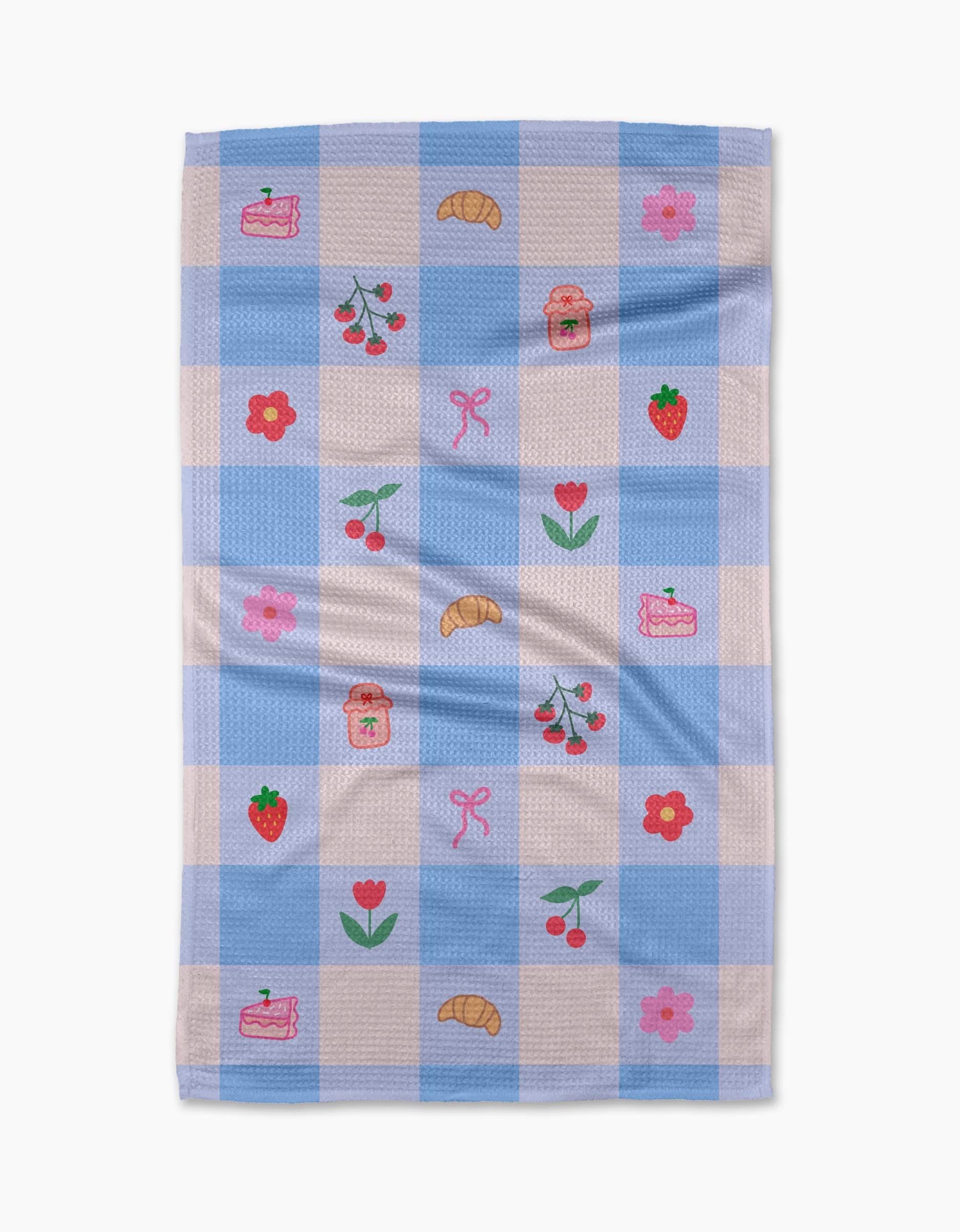 The Little Picnic Things tea towel by Letters By Shells is made from recycled materials and features blue and white checks with embroidered croissants, cherries, strawberries, jam jars, cake slices, pink bows, red tulips, and pink flowers.