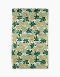 The Maple Leaves tea towel by Sarah Daugherty features a repeating pattern of green and yellow maple leaves on white, creating a botanical, nature-inspired look for your kitchen.