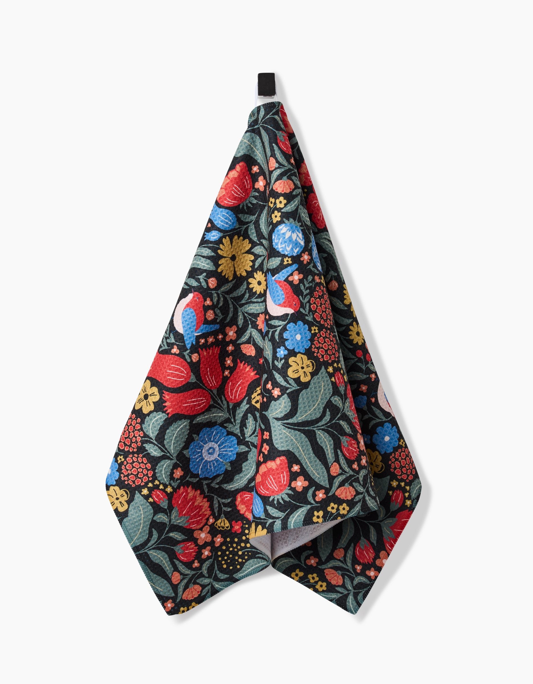 The Marsh Wren tea towel by Danelys Sidron features a vibrant floral pattern in red, blue, yellow, and green. Made from ultra-absorbent Geoweave fabric, it combines style and functionality and hangs from a black loop against a white background.