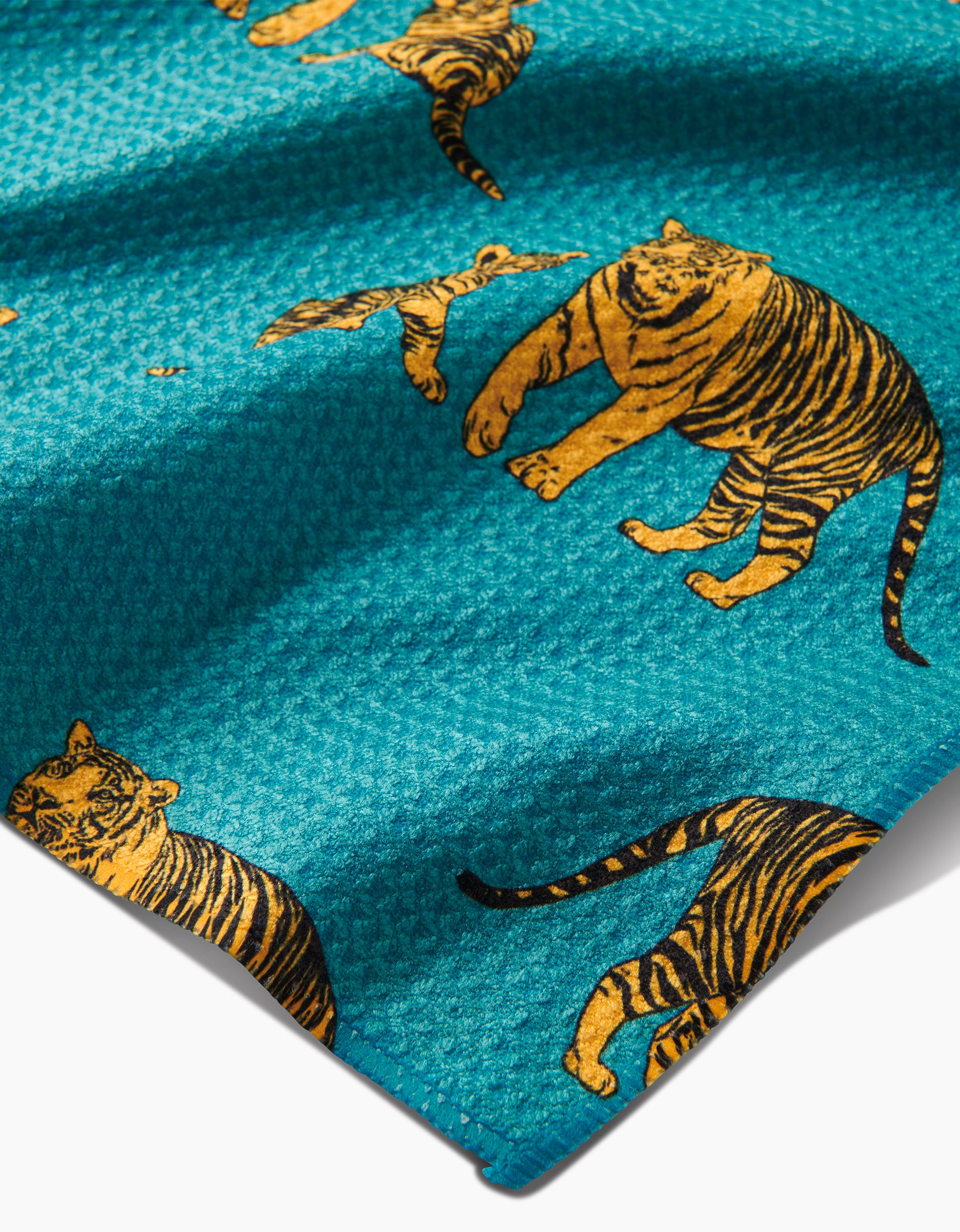 Mommy and Me by Sarah Holden is a teal Geoweave tea towel with yellow and black tigers in various poses, made from recycled materials for a unique touch.
