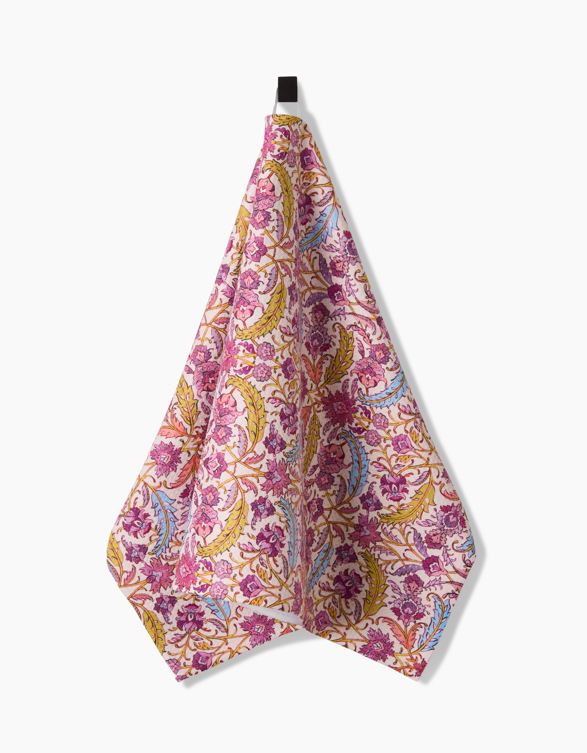 A Morning Glory tea towel by Maayan Alper-Swan, made from Geoweave fabric, hangs from a black loop against a white background and features a floral pattern with pink, purple, yellow, and green accents.