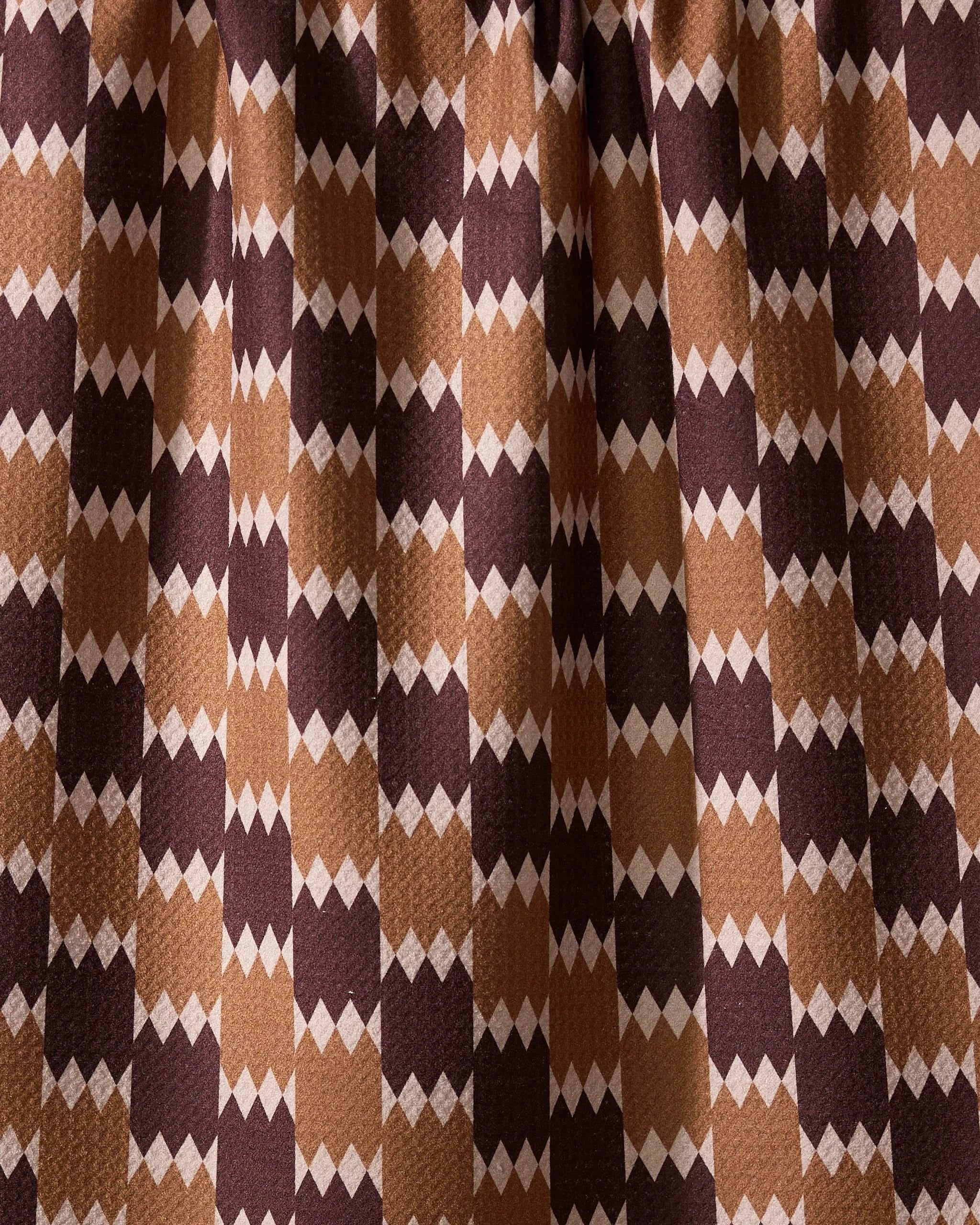 The Geometry Mountain Song recycled kitchen towel features a visually dynamic geometric pattern with alternating brown, tan, and beige diamond shapes in vertical rows.