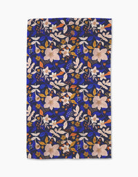 Nightfall Garden by Cottonflower Studio is a rectangular tea towel featuring a vibrant floral print in pink, white, and orange on deep blue. The decorative design covers the ultra-absorbent kitchen towel made from recycled materials.