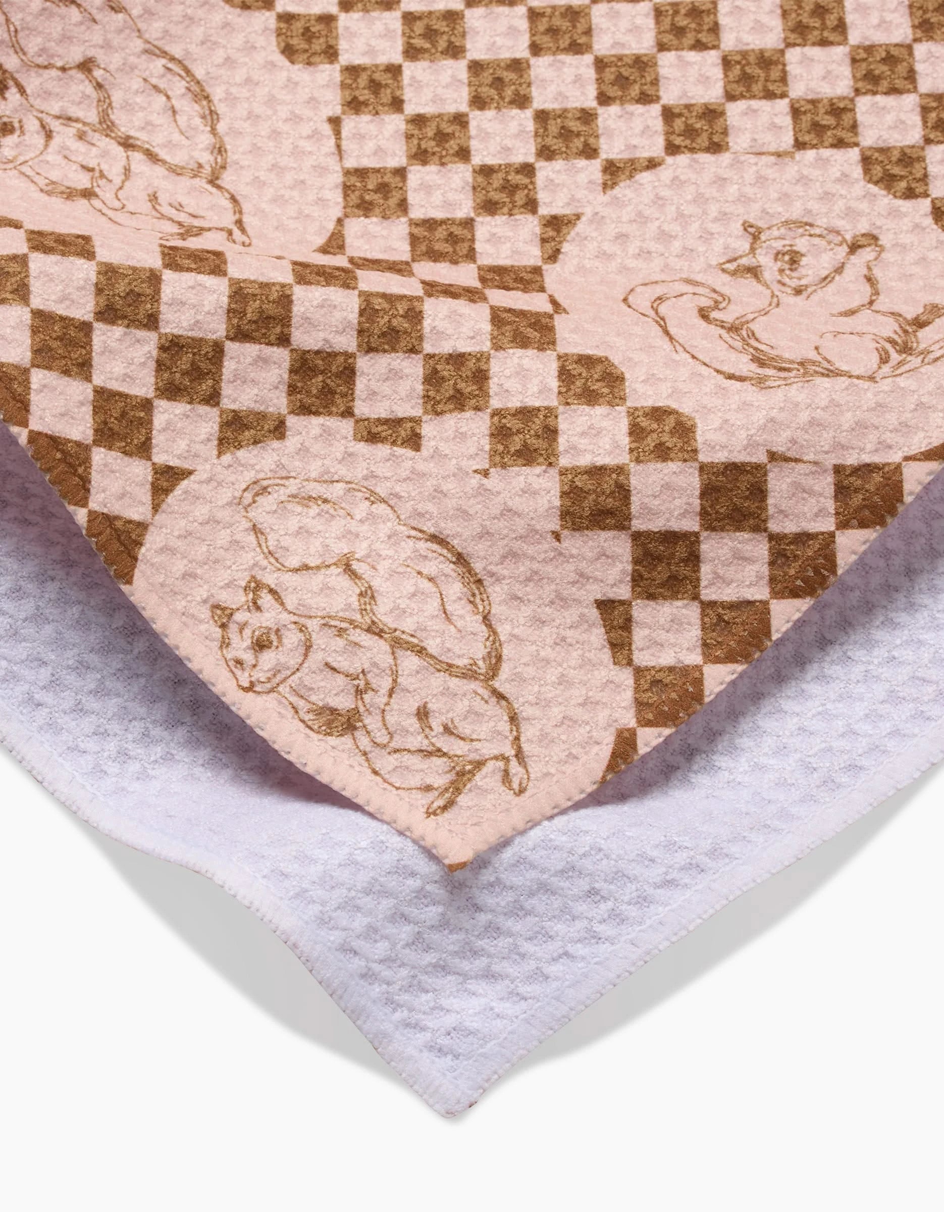 Aubrey Fairchilds Nuts About You tea towel features playful squirrel illustrations on pink and brown checks, layered over white textured cloth. Made from recycled materials, this quick-drying towel brings eco-friendly charm to your kitchen.