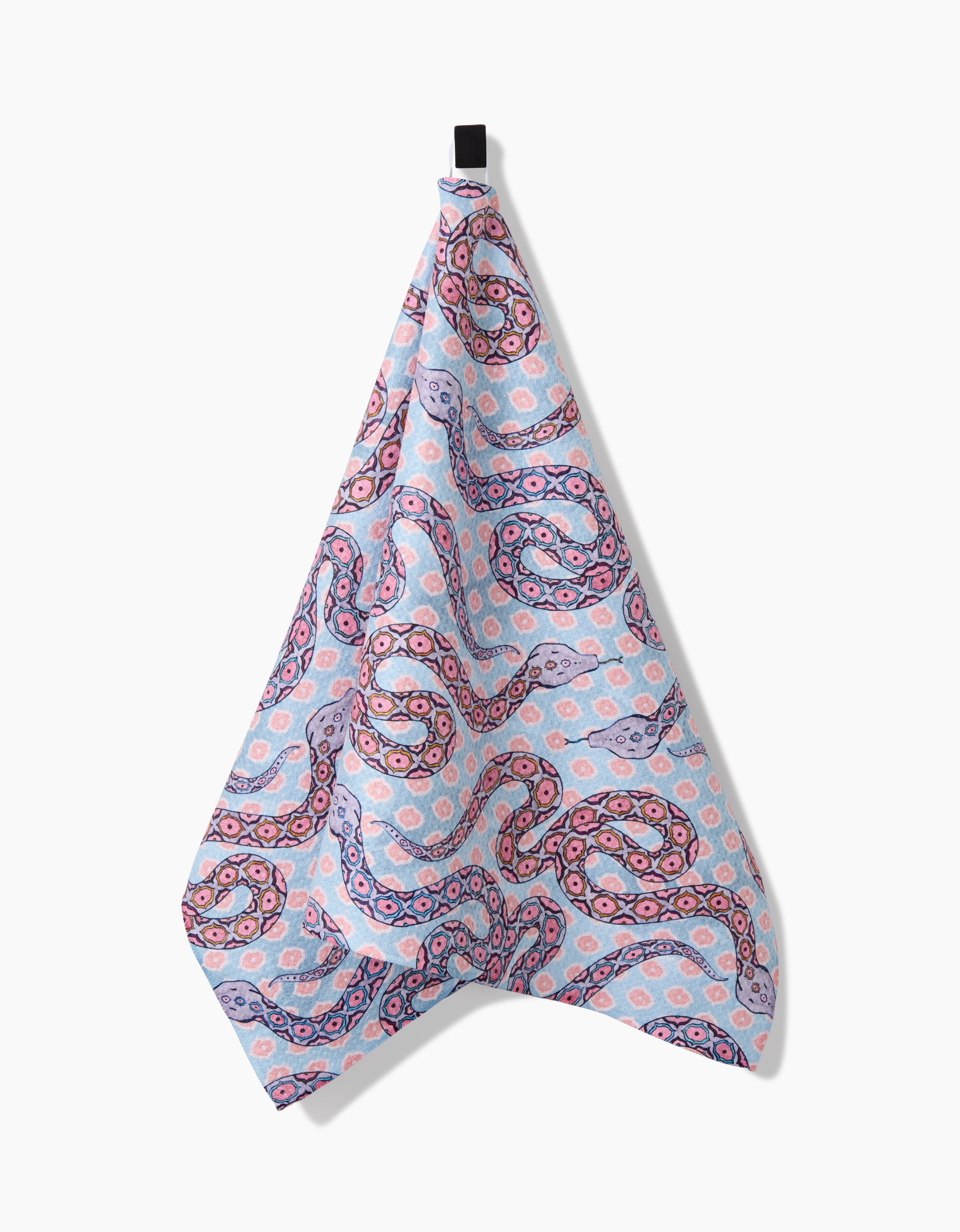 A light blue Ophidia Tea Towel by Maayan Alper-Swan with pink, purple, and blue swirls hangs from a black hook on a white background. Made from ultra-absorbent post-consumer recycled materials for sustainable style.