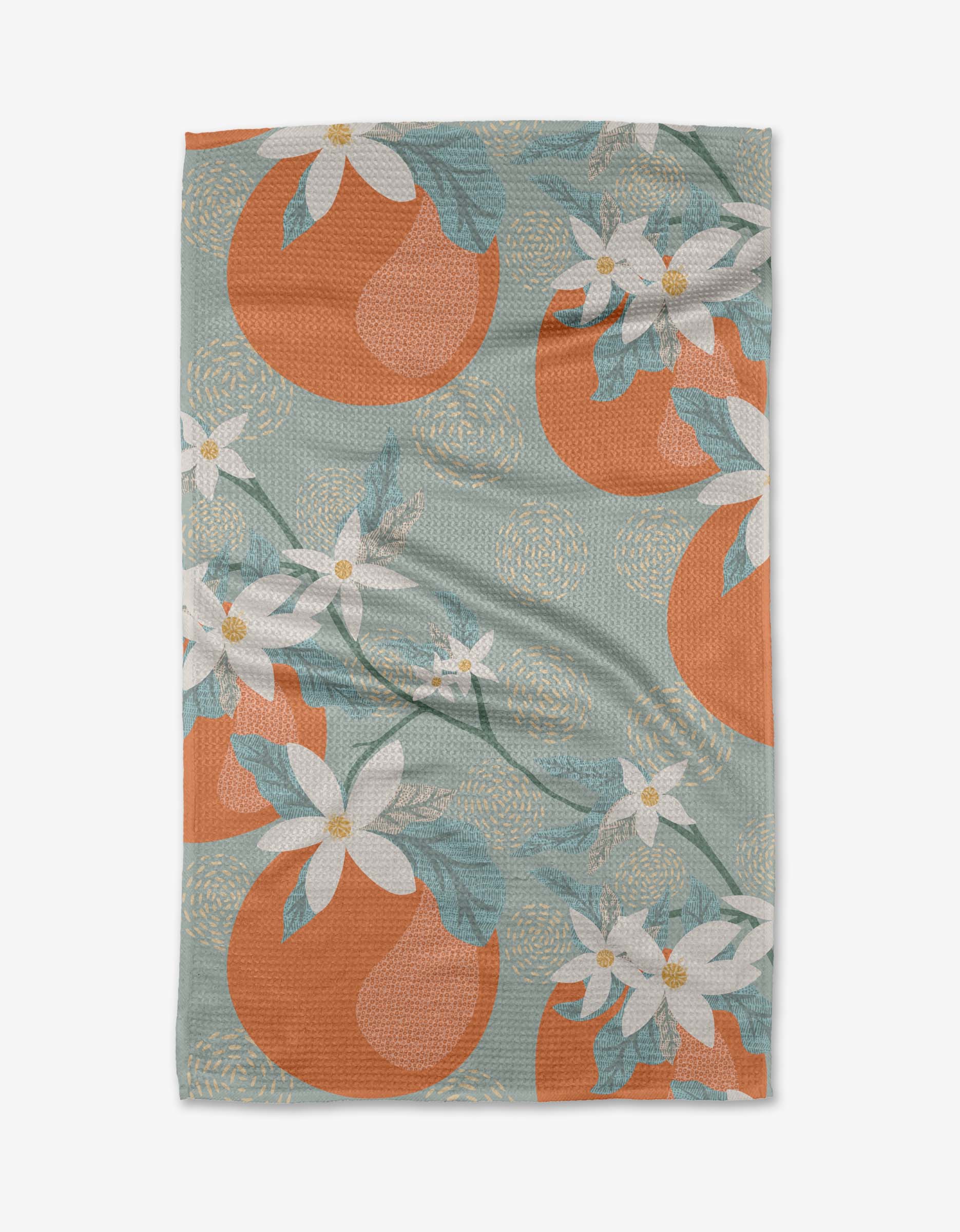 The Julianne Haness Orange Blossom tea towel features an orange and white floral pattern with large oranges, white flowers, green leaves, and swirls on a light green background. Made from ultra-absorbent Geoweave™ fabric for superior drying.