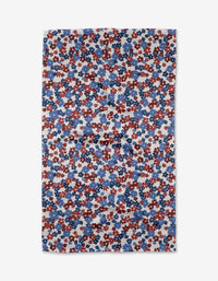 The Painted Petals Kitchen Tea Towel by Ashley Celena features a rectangular Geoweave fabric with a dense floral pattern of red, white, and blue flowers on a light background, viewed from above.