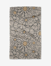 Paulette by Amy MacCready is a rectangular ultra-absorbent fabric featuring a repeating pattern of black outlined flowers with beige centers on a light background.