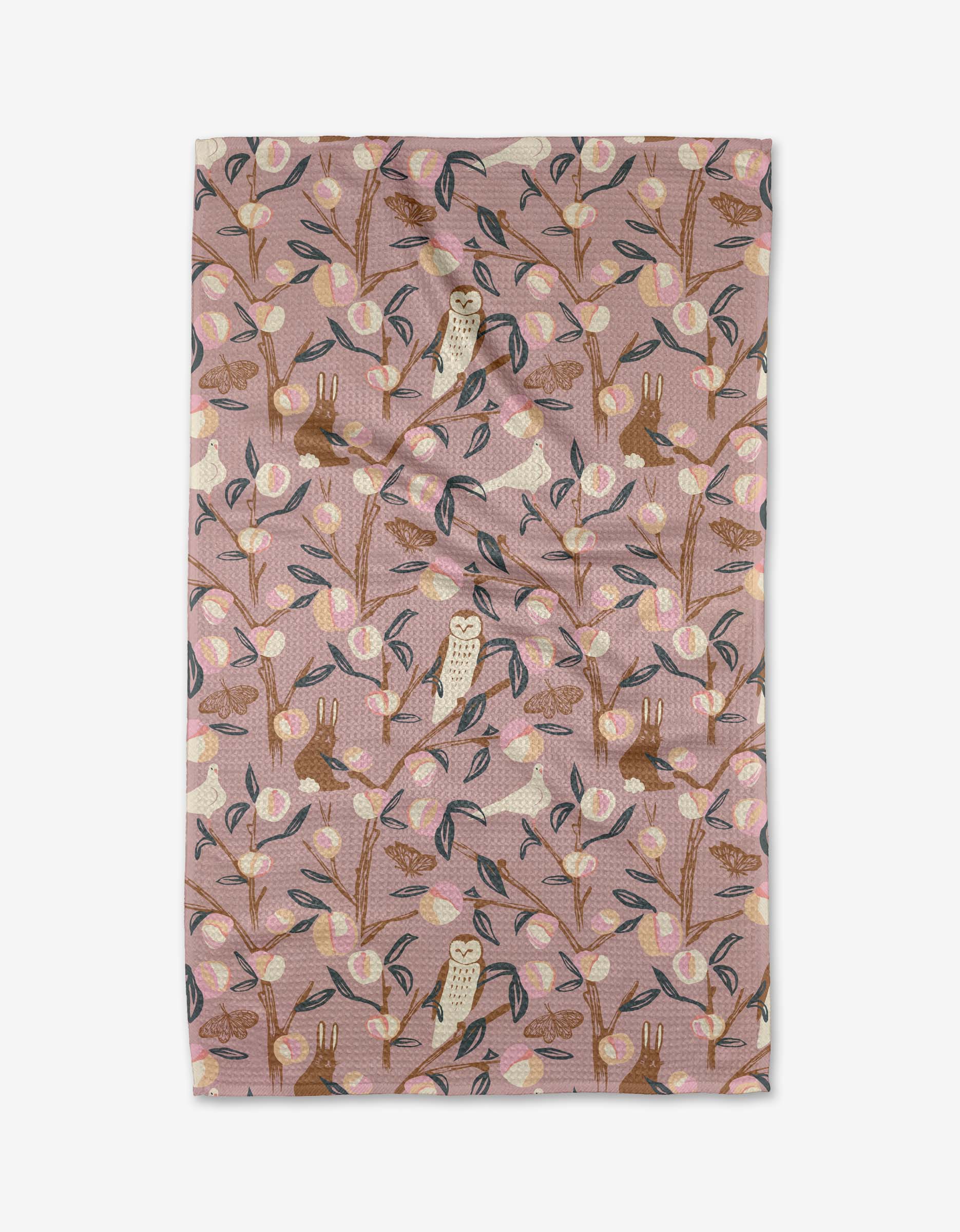 A Peach Tree tea towel by Elisabeth Wing featuring a whimsical woodland pattern with owls, rabbits, and branches in soft pastel colors, made from ultra-absorbent Geoweave fabric.