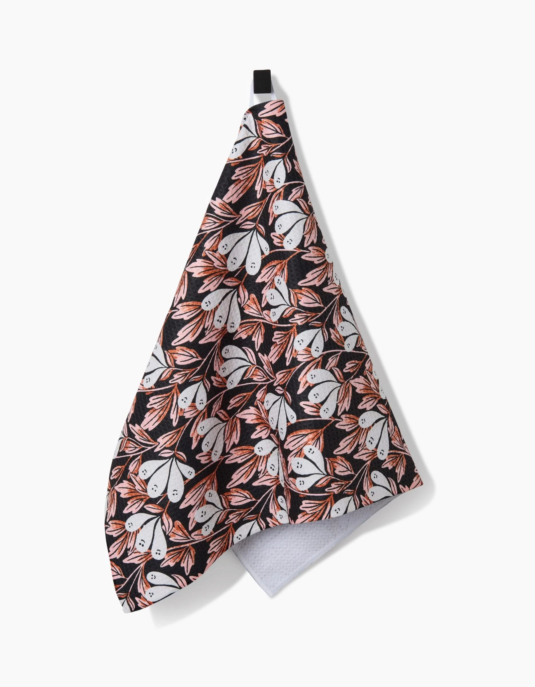 The Phantom Floral recycled kitchen towel by Sarah Daugherty features a black background with white and orange moths and a small black hanging loop for easy display.