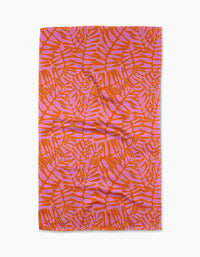 The Pink Modern Palm tea towel by Katie OShea features an orange and pink tropical palm design on white, made from recycled materials—an eco-friendly, stylish kitchen upgrade.
