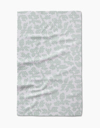 The Pixie Sage tea towel by Studio Jeannot features a subtle green dotted leaf pattern on white, crafted from recycled materials and shown flat against a white background.