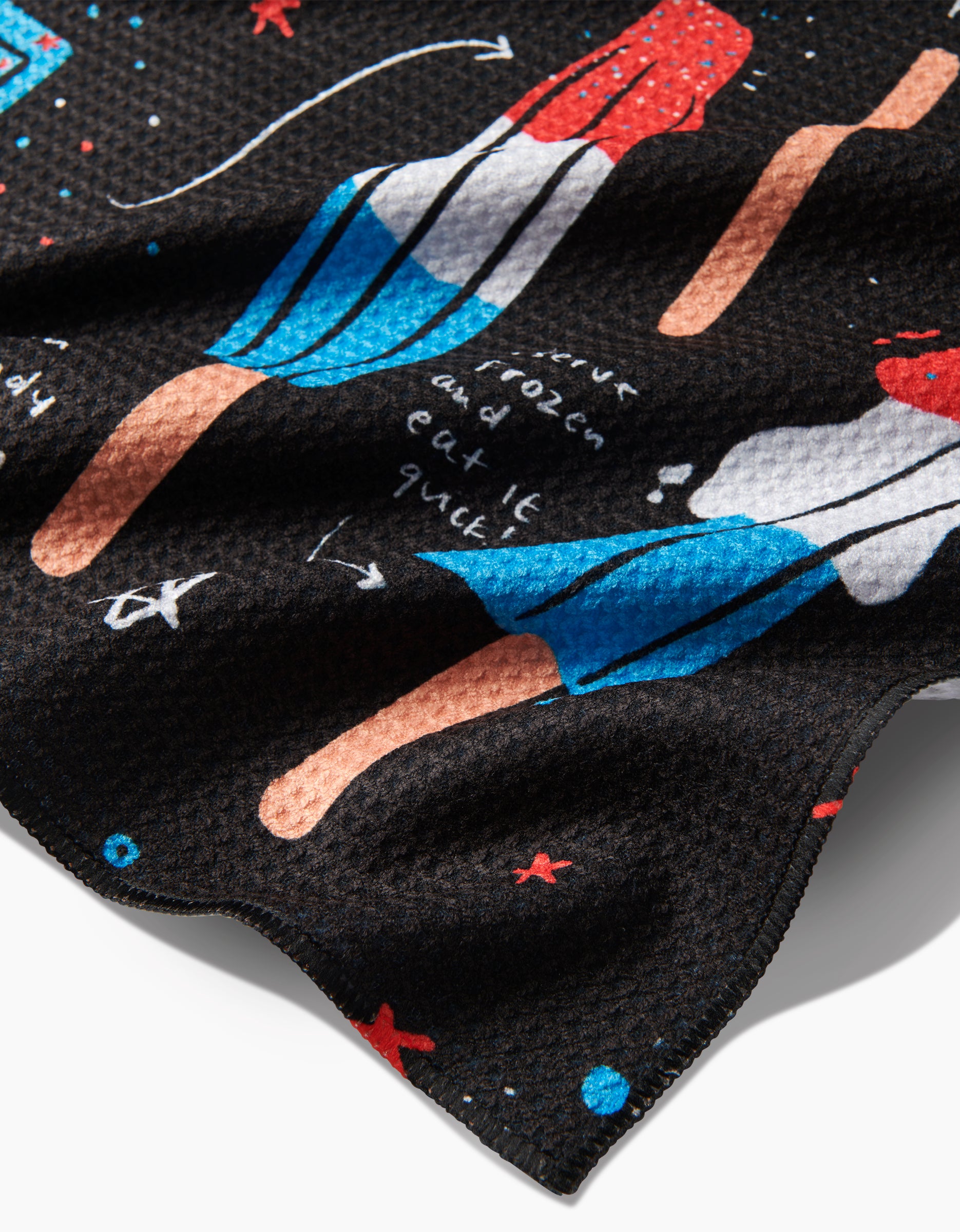 Close-up of a Janna Sue Design Popsicles tea towel made with textured Geoweave fabric, featuring colorful red, white, and blue popsicle illustrations with playful handwritten text and doodles.