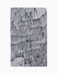 The Geometry Posh Petals Fresh Linen towel features a black-and-white abstract petal design with overlapping wavy shapes and intricate lines on a crisp white background, all crafted from quick-drying material.