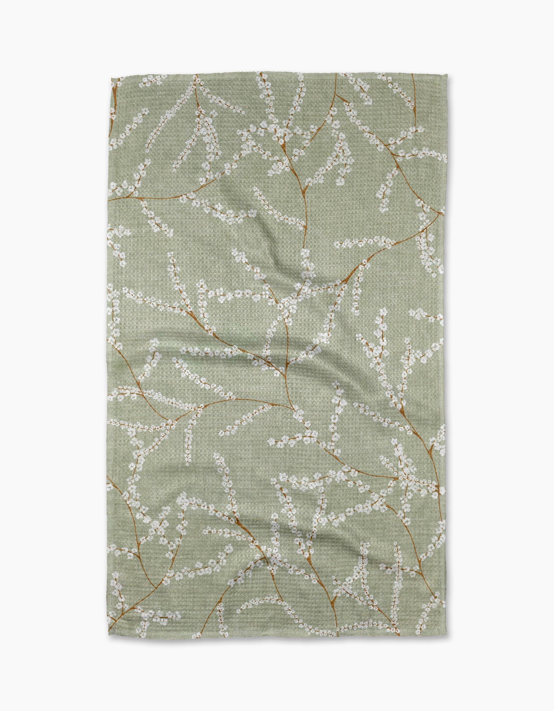 The Quiet Flowers tea towel by Pascale Dilger features a light green rectangle adorned with white cherry blossom branches on brown stems. Made from recycled materials, its slightly textured fabric is shown flat against a white background.