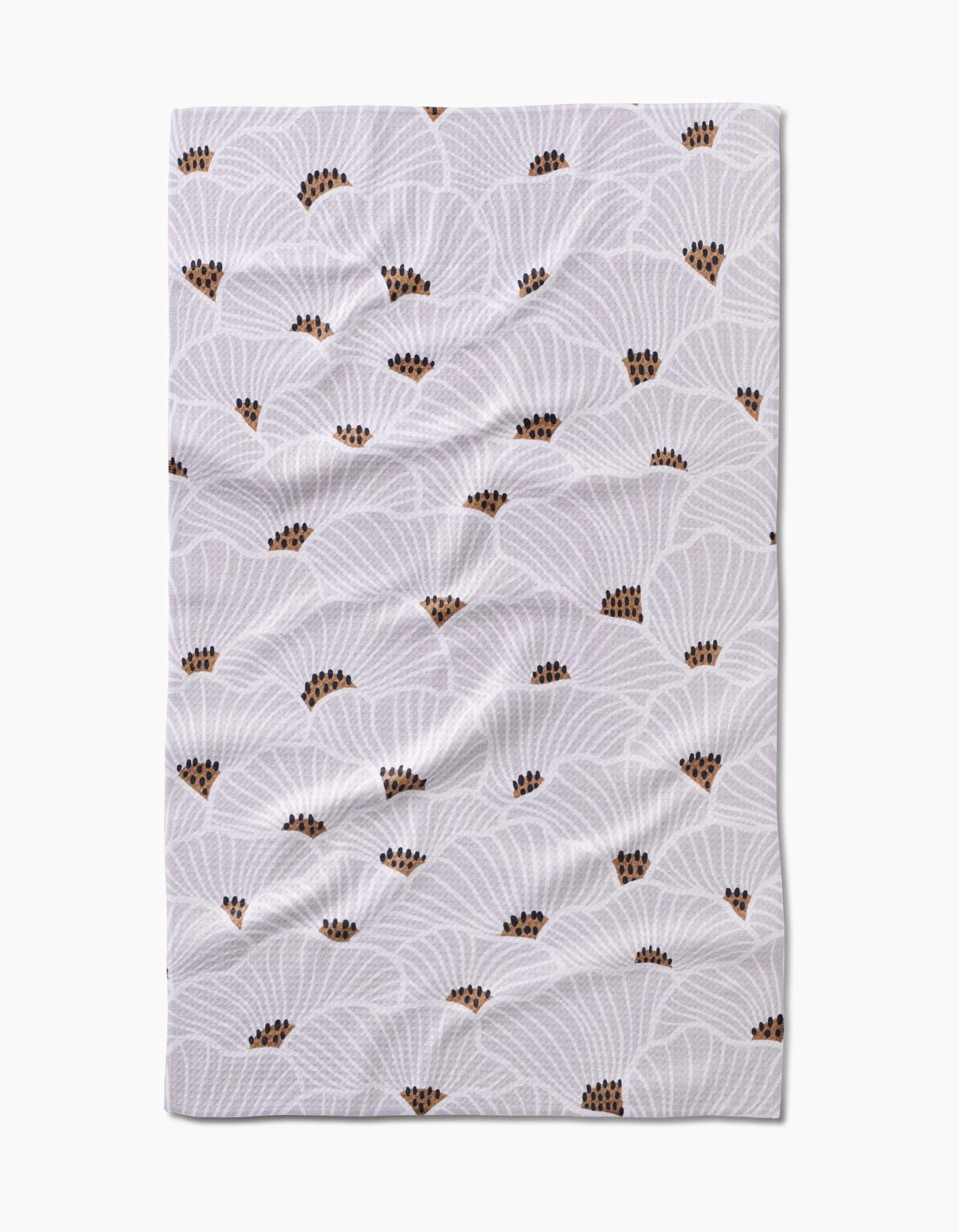 The San Diego Tea Towel by Amy MacCready features a white Geoweave™ fabric with a repeating pattern of overlapping, fan-shaped light grey designs and small brown and black accents. The rectangular towel may appear slightly wrinkled.
