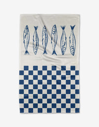 The Hufton Studio Sardine Check Blue tea towel features five blue fish along the top and a blue-and-white checkered pattern on the bottom half, printed on white Geoweave fabric.