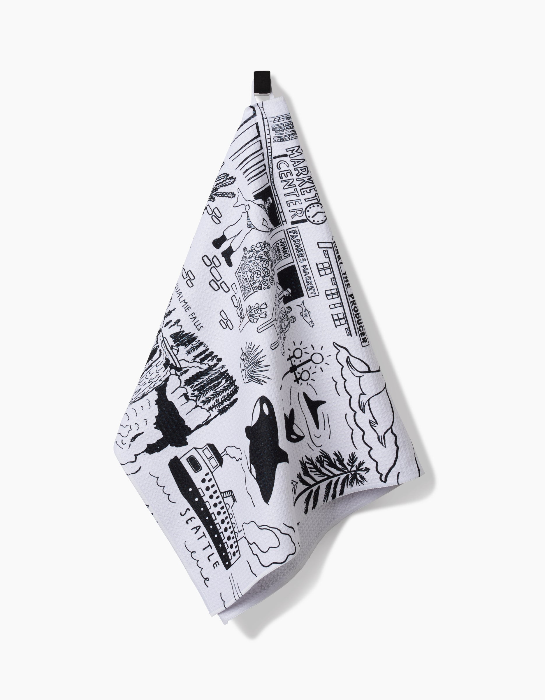 The Seattle tea towel by Elisabeth Wing showcases black illustrations of city landmarks on white Geoweave fabric. It hangs from a black loop and is crafted from recycled materials for an eco-friendly touch.