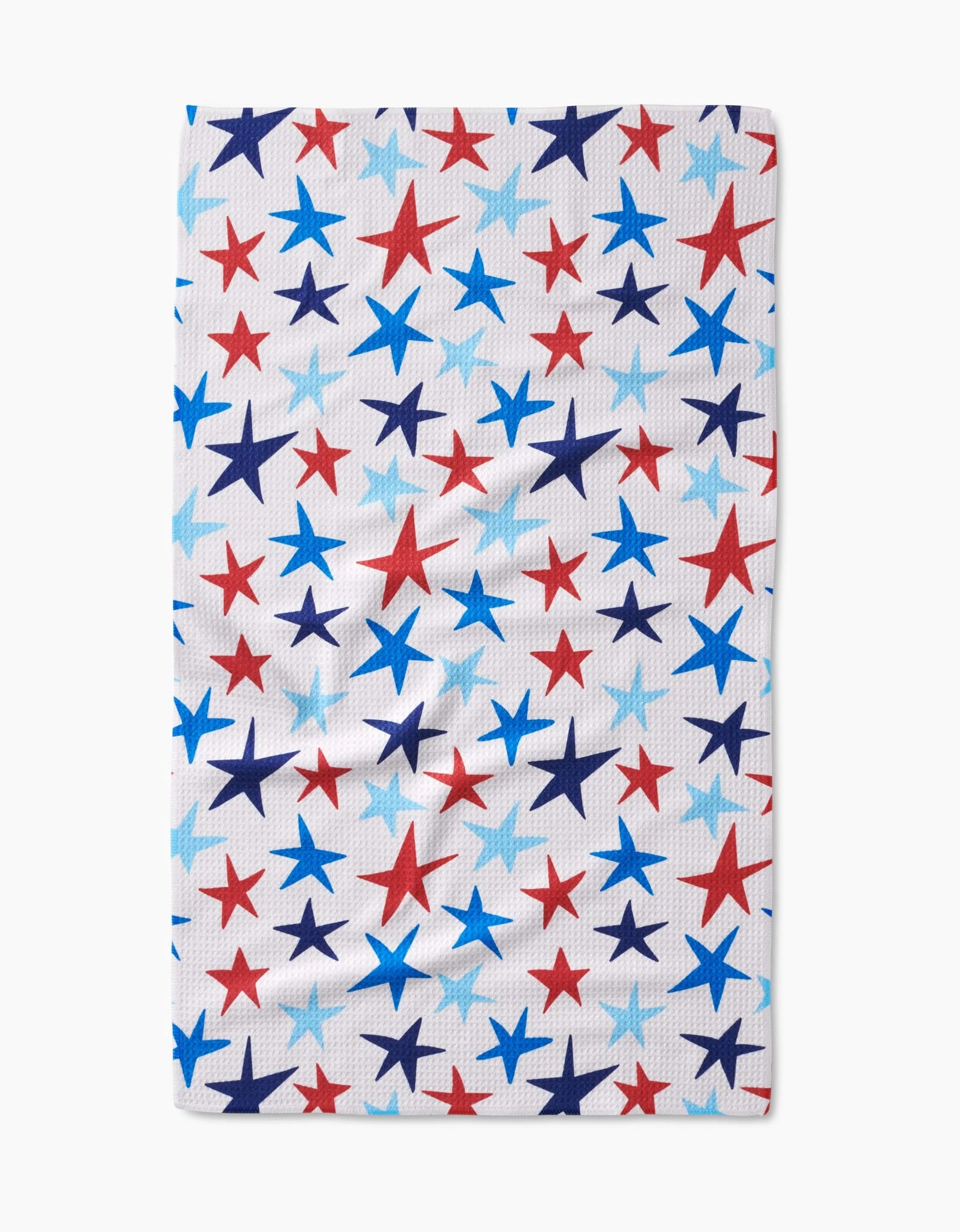 The Mindfulnice Seeing Stars tea towel is white and rectangular, featuring red, blue, and light blue stars in various sizes on Geoweave™ fabric.