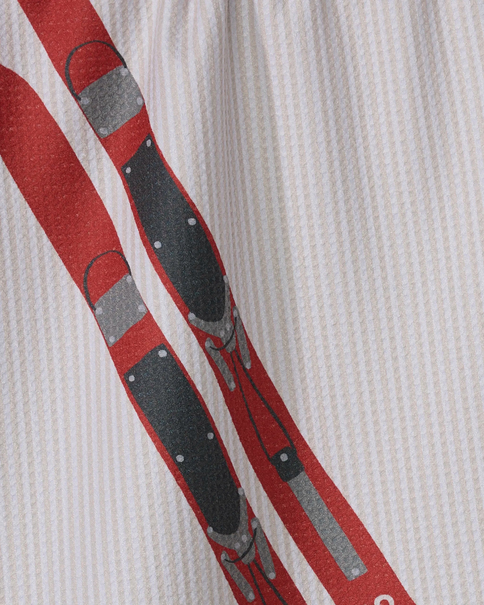 Close-up of the Geometry Snowcap tea towel in white with subtle vertical stripes, featuring a red and black graphic resembling two stylized fencing swords.