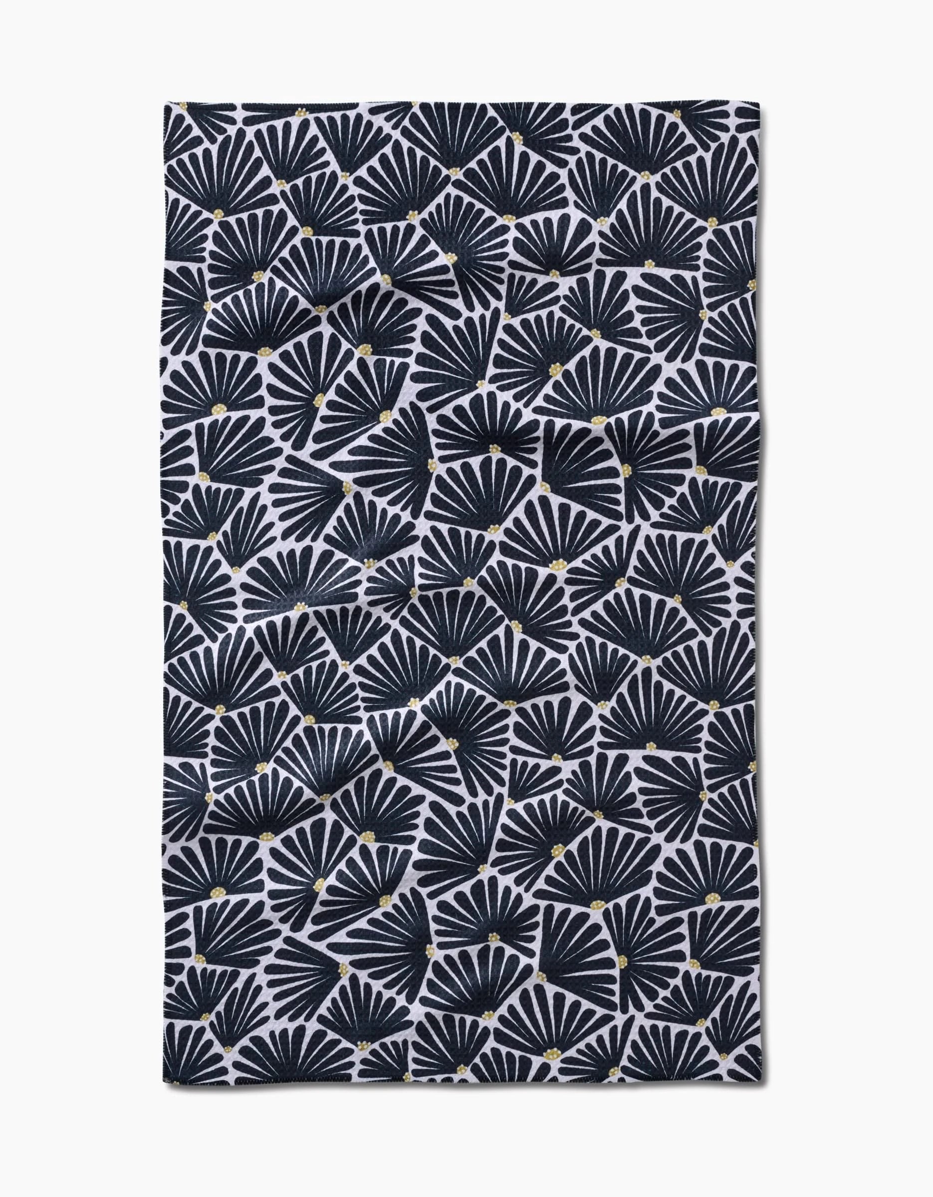 The Solie Black Tea Towel by Amy MacCready features black fan-shaped leaves and yellow dots on white Geoweave™ fabric. Its ultra-absorbent, rectangular design with slightly uneven edges adds a charming touch.