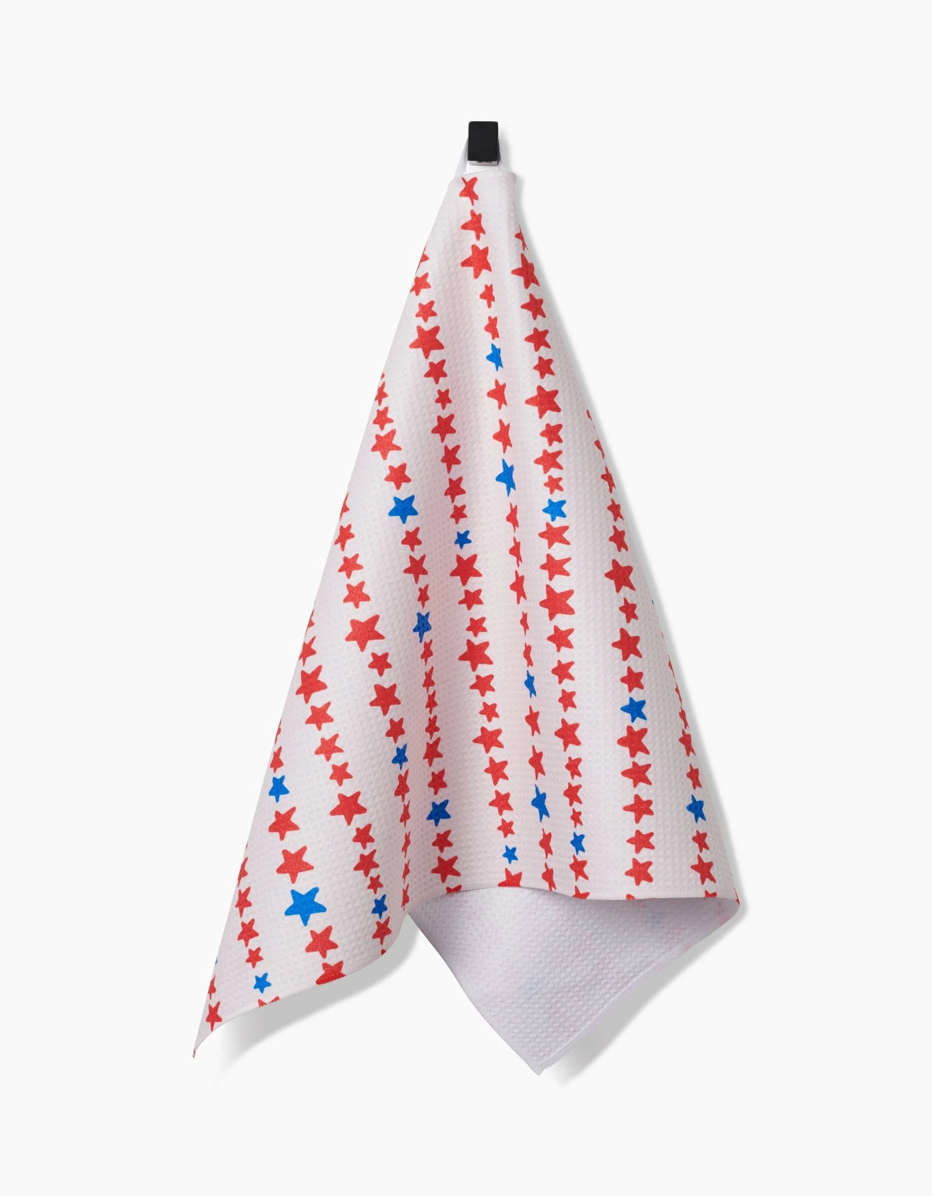 A Kayla Ann Starry Stripes tea towel in white hangs from a black loop, featuring vertical red and blue star stripes and crafted with durable Geoweave™ fabric.