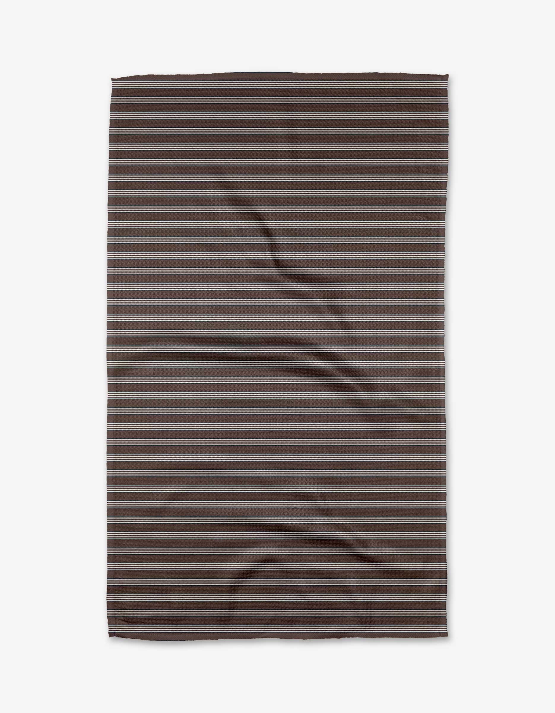 The Straight Across - Chocolate blanket by The Buy Guide features horizontal stripes in brown and gray tones, is made from recycled materials, and is shown flat on a white background with some creases.