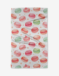 The Elena Fay Sweet Macarons Tea Towel features a watercolor pattern of pink, green, and orange macarons with dots on white Geoweave fabric for softness and absorbency.