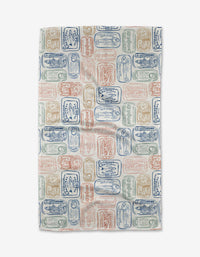 The Tinned Sardines Tea Towel by Hufton Studio features a colorful pattern of sardine cans in blue, red, and green on white Geoweave fabric, offering exceptional absorbency and durability.