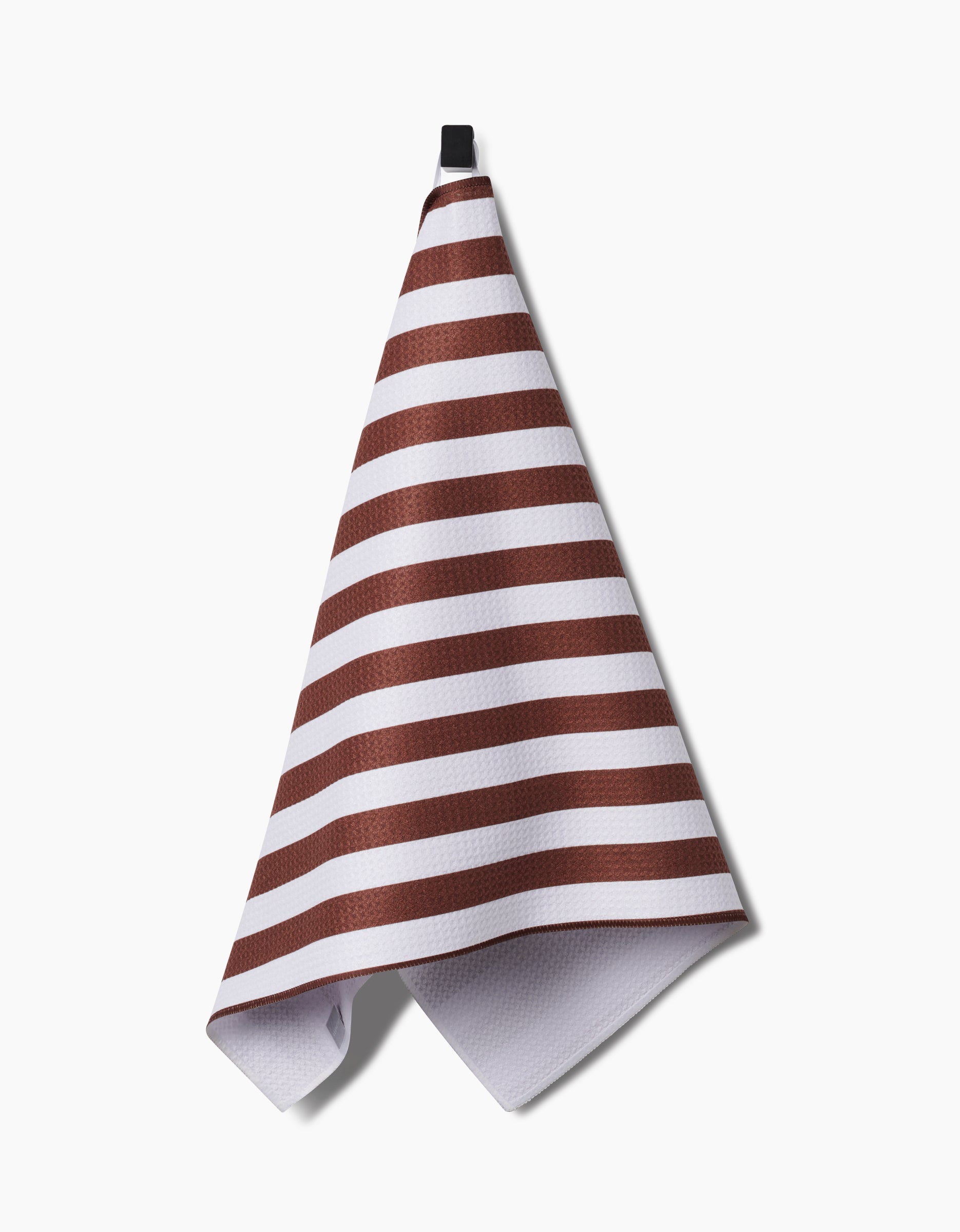 The Kailee Wright Toni Stripe tea towel, made from recycled materials, features white Geoweave™ fabric with horizontal brown stripes and hangs from a black loop against a plain white background.