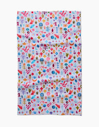 The Tula Tea Towel by Maayan Alper-Swan showcases a vibrant abstract floral and geometric pattern in red, blue, yellow, orange, and pink on white Geoweave fabric that is soft and eco-friendly.