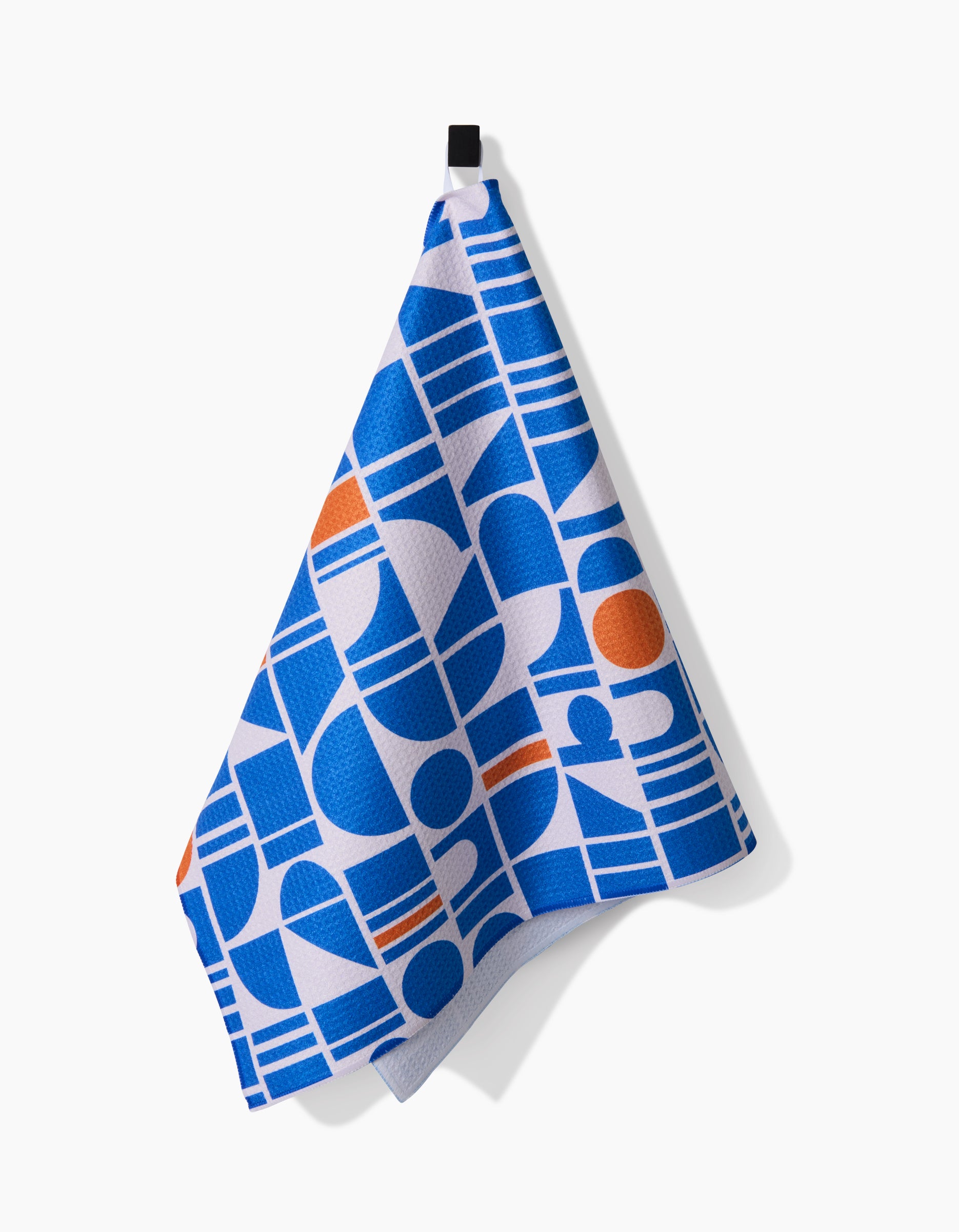 The Ultra Marine Harmony hanging towel by Happy Hemera features bold blue, white, and orange geometric circles and rectangles on ultra-absorbent Geoweave fabric with a crisp white background.