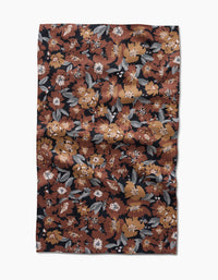 The Hufton Studio Vintage Floral Natural Tea Towel features a rectangular Geoweave fabric with a dense floral print in brown, orange, white, and gray on black. The ultra-absorbent towel has a slightly wrinkled texture.