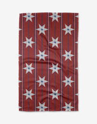 The Ashley Celena Vintage Stars tea towel showcases a red background with vertical blue lines and white eight-pointed stars in a grid. Made from ultra-absorbent fabric, it’s shown slightly wrinkled on a white backdrop.