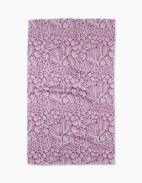 The Violet Paper Flowers tea towel by Katie OShea features an intricate floral pattern in pink and white, with densely arranged flowers and leaves—perfect for adding charm to any kitchen.