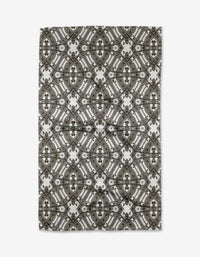 The Walk The Line Shimmy rug by Katherine Berkeley features a symmetrical geometric pattern in gray, black, and white, offering an intricate and stylish accent reminiscent of ornate dish towel designs.