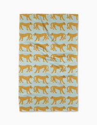 The Walking Cheetah tea towel by Jasmine Blooms Designs features a light blue background with a repeating pattern of stylized yellow cheetahs with black spots walking in alternating directions.