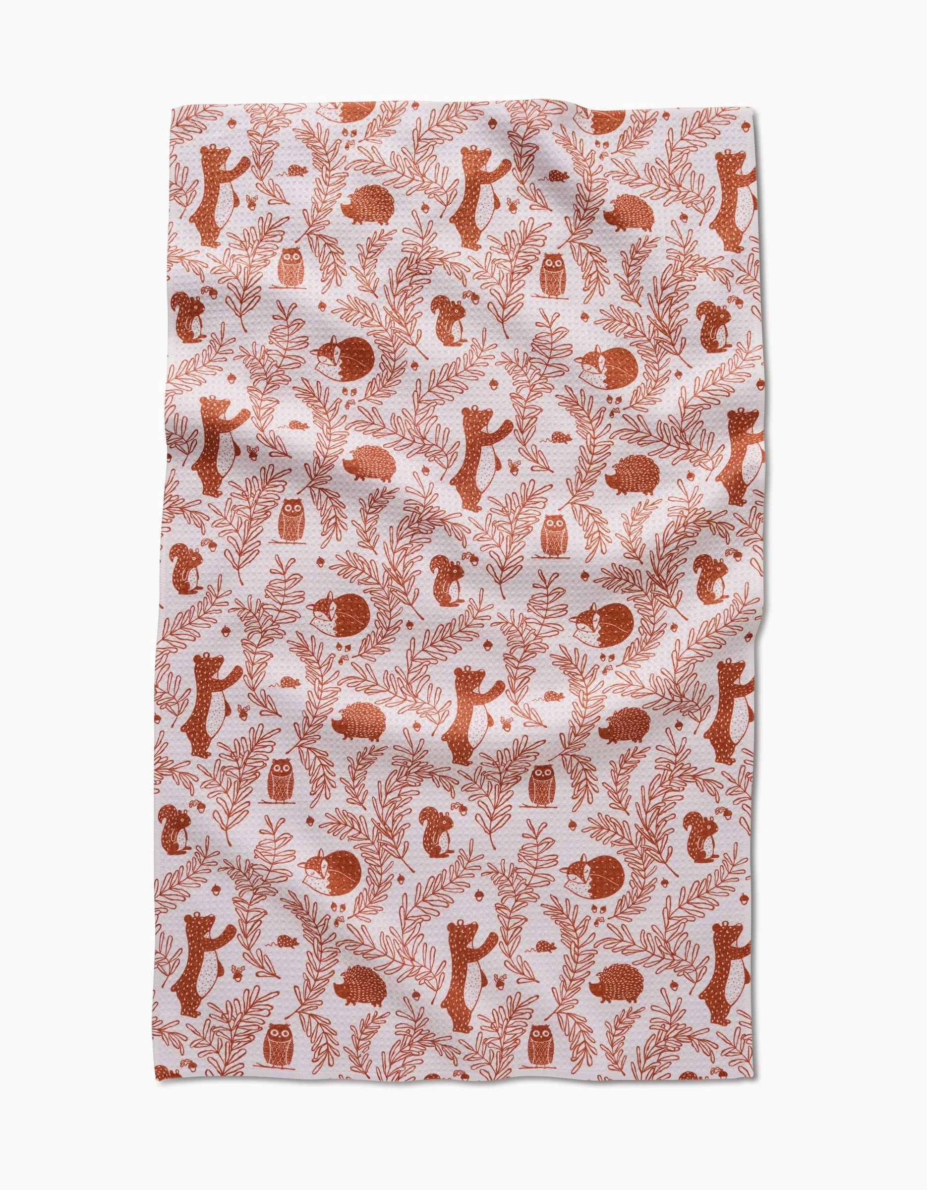 The Sara Mari Whimsical Woodland bar towel features red bears, squirrels, and hedgehogs with leaves and branches on white recycled fabric. The slightly wrinkled cloth is displayed flat.