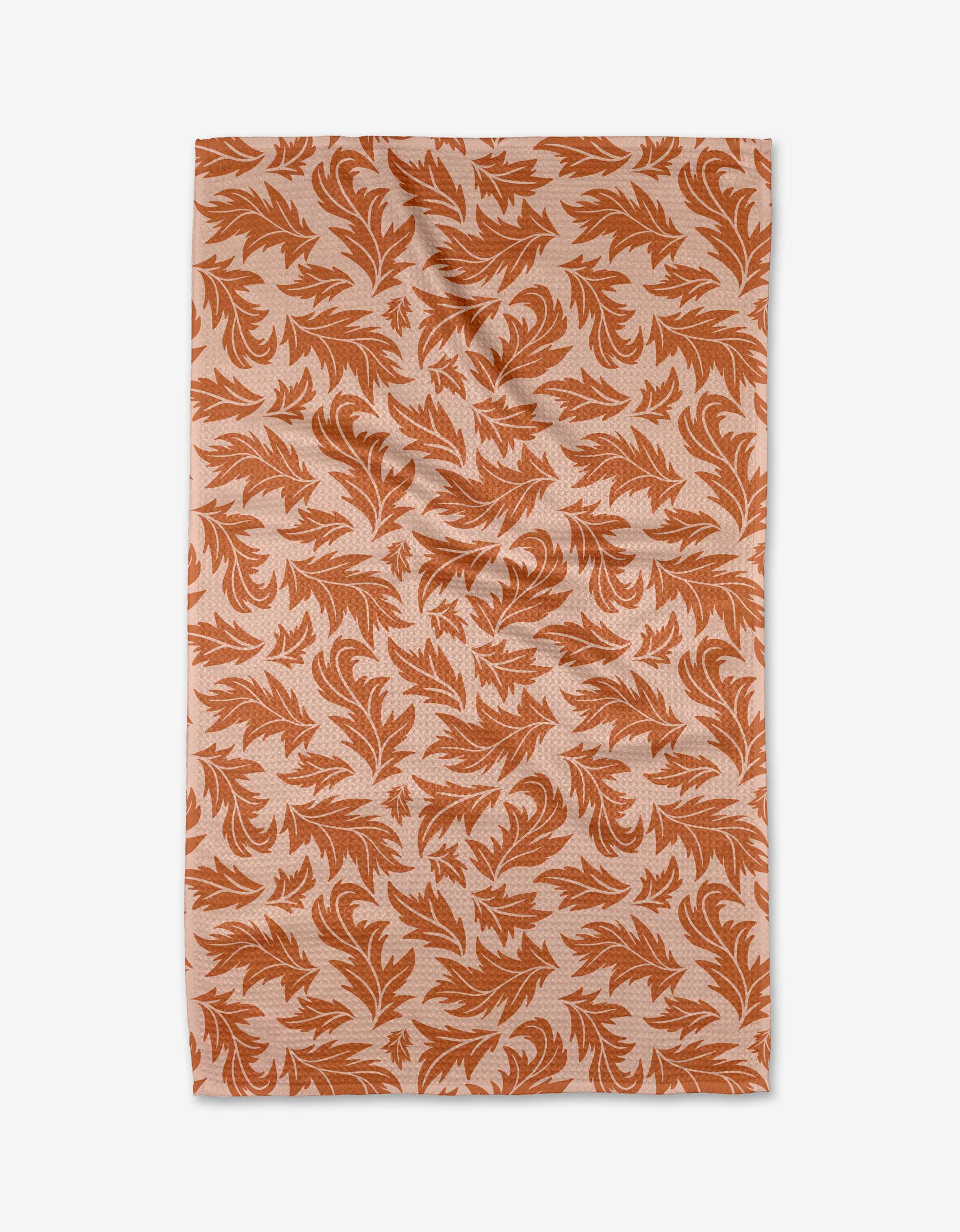 The Wind Fall by Danelys Sidron is a rectangular, ultra-absorbent fabric featuring an orange leaf pattern on a light beige background, shown laid flat with slight wrinkles.