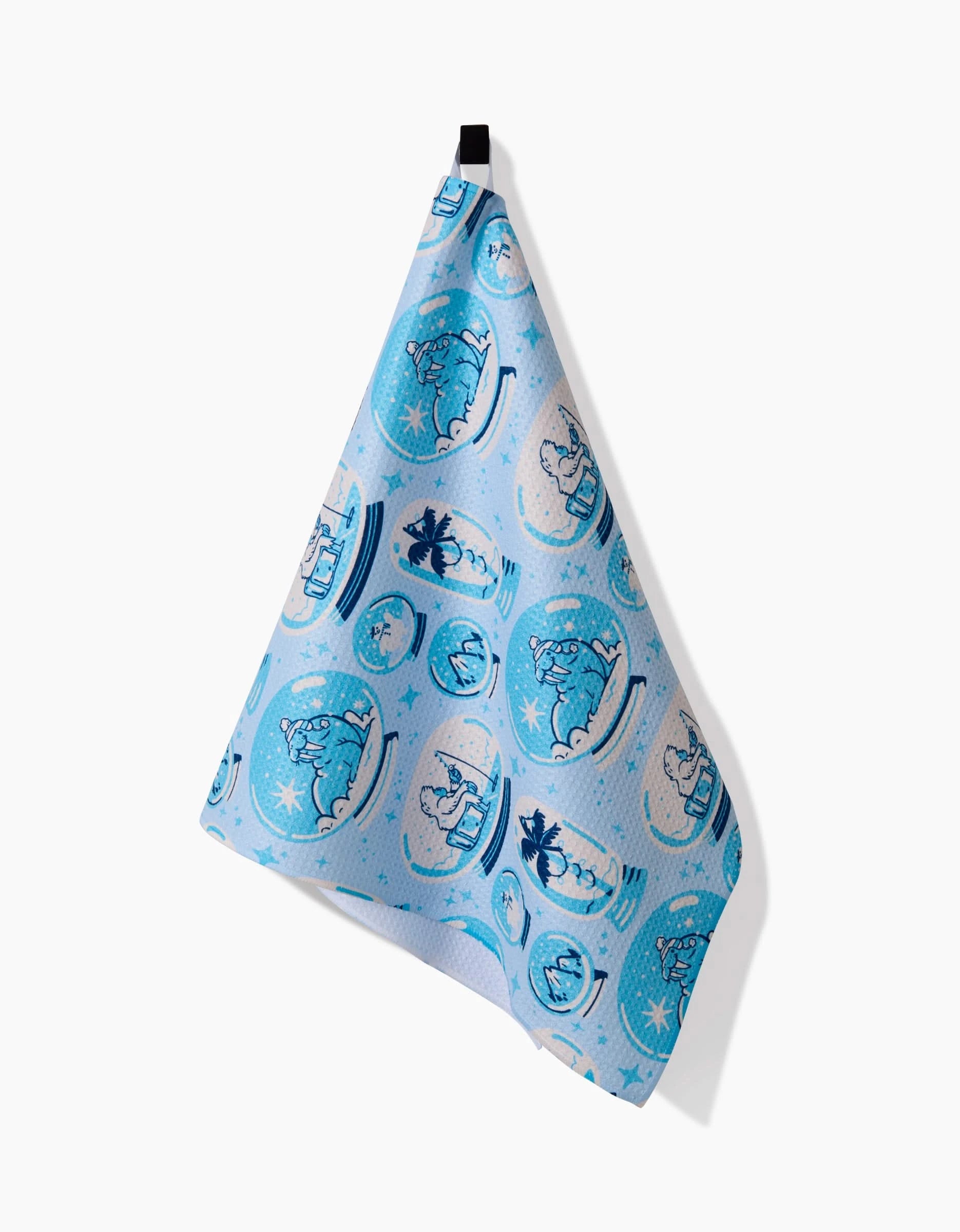 The Carly Berry Winter Snow Globe Collection tea towel, crafted from recycled materials, showcases polar bears and blue snow globes and hangs by a black loop against a white background.