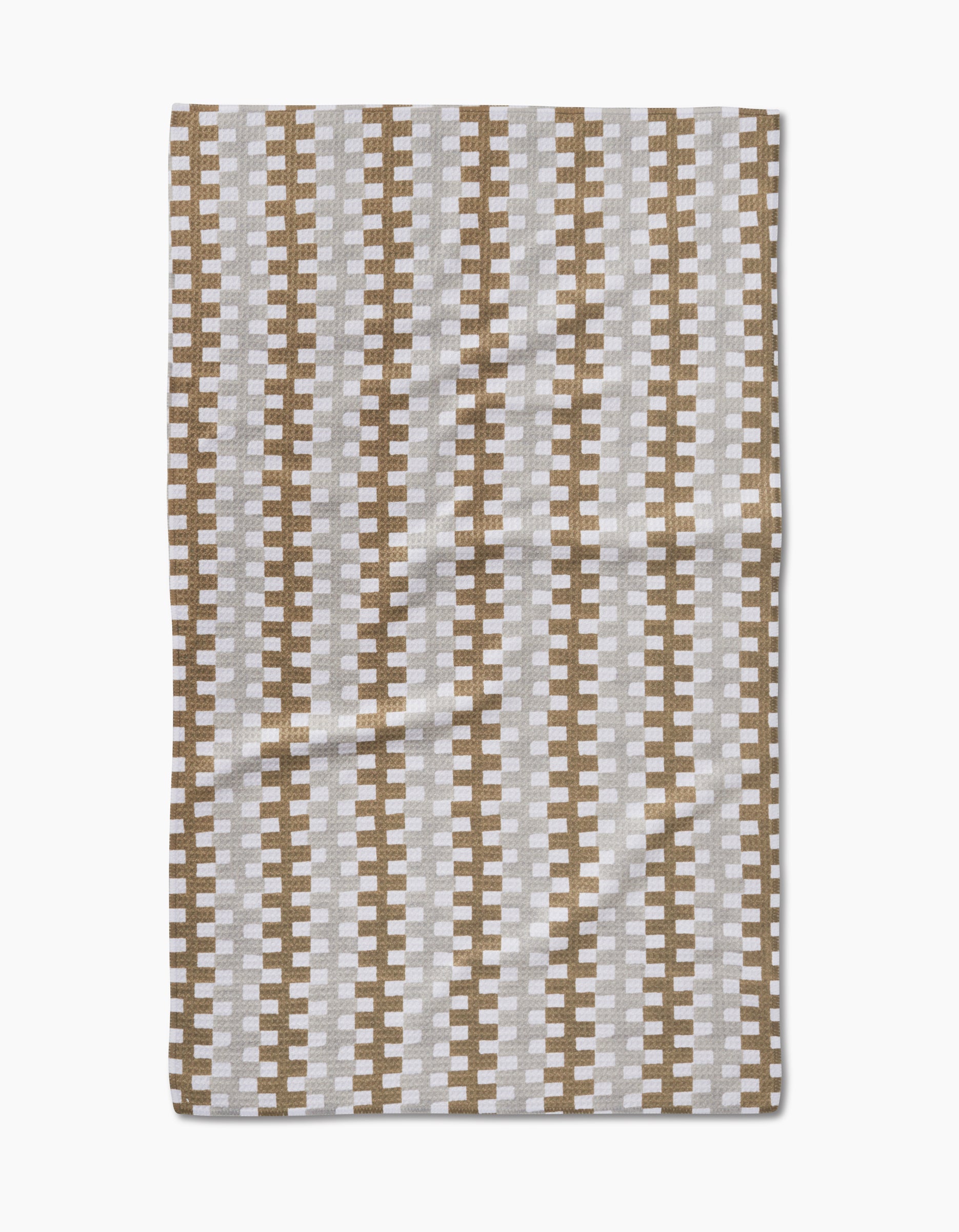 The Studio Jeannot Zippy is a rectangular ultra-absorbent dish towel featuring a repeating geometric pattern of vertical brown and white zigzag stripes on a light background, shown laid flat.