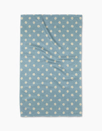 The Geometry Freckle Light Blue towel, featuring evenly spaced white polka dots on a rectangular light blue quick-drying fabric, is laid flat on a white background—ideal as a stylish and functional kitchen tea towel.