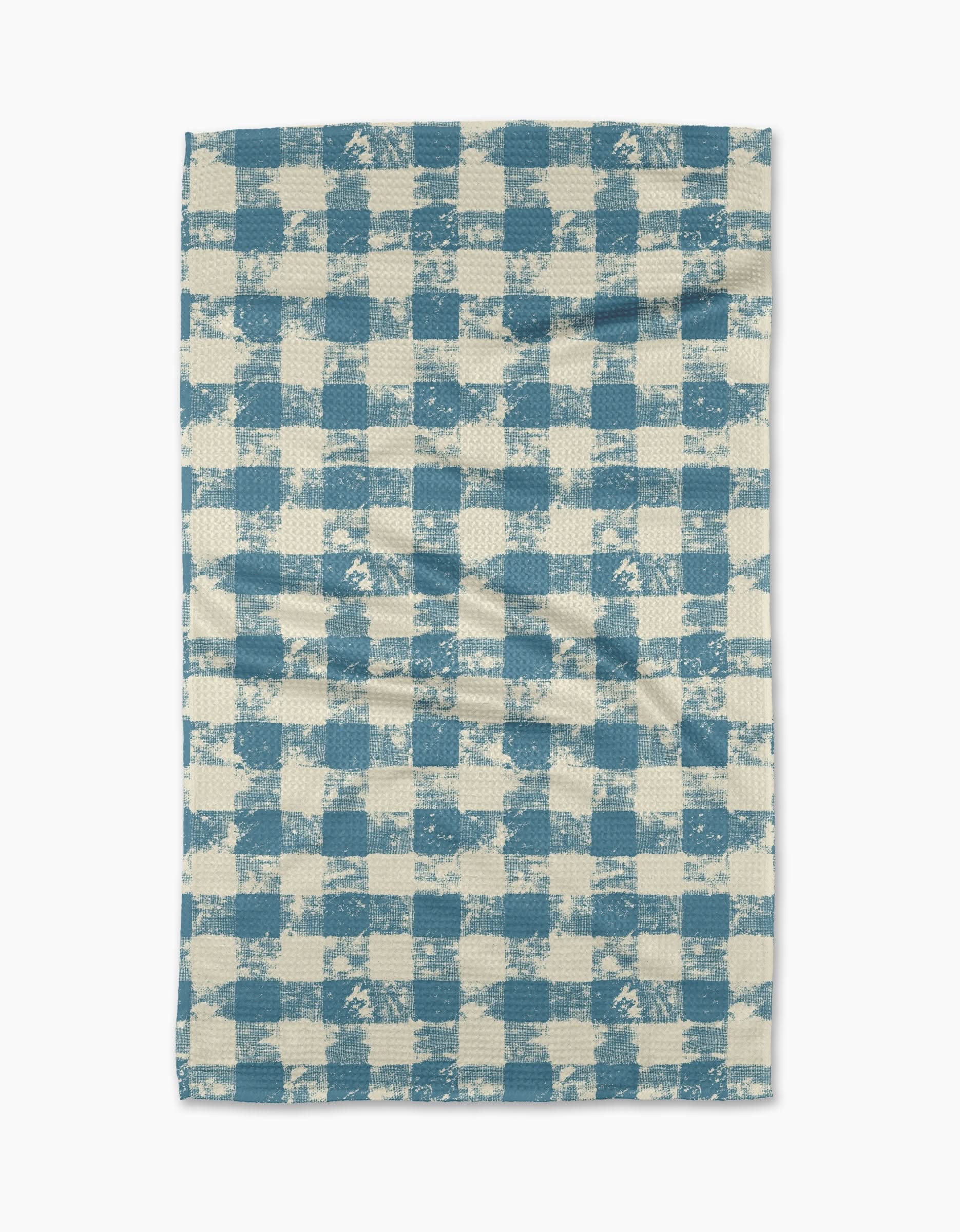 The Patch Denim tea towel by Geometry features a blue and white checkered pattern with a textured, slightly uneven design, displayed flat on a white background.