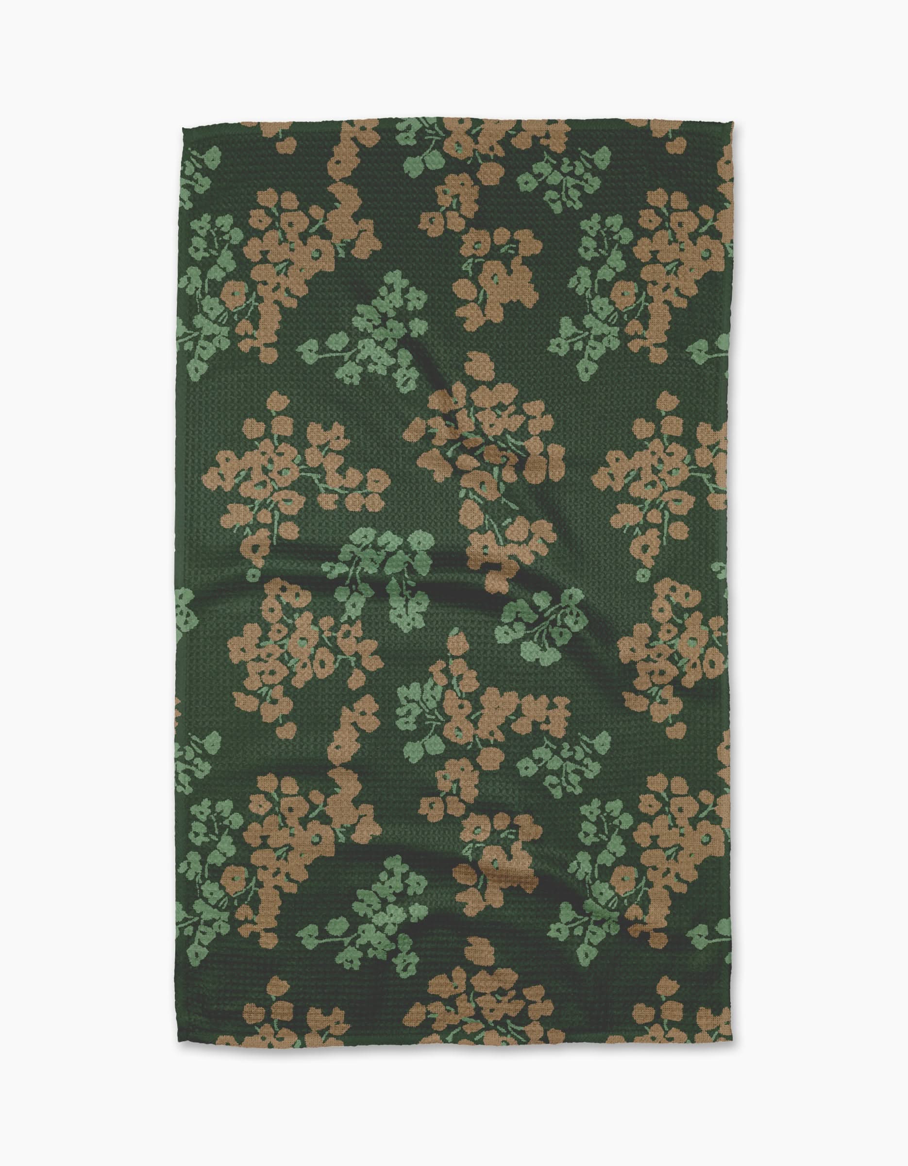 The Geometry Sonnet Forest tea towel features a rectangular shape in dark green with tan and light green floral clusters. Ultra-absorbent, it’s shown laid flat on a white background.
