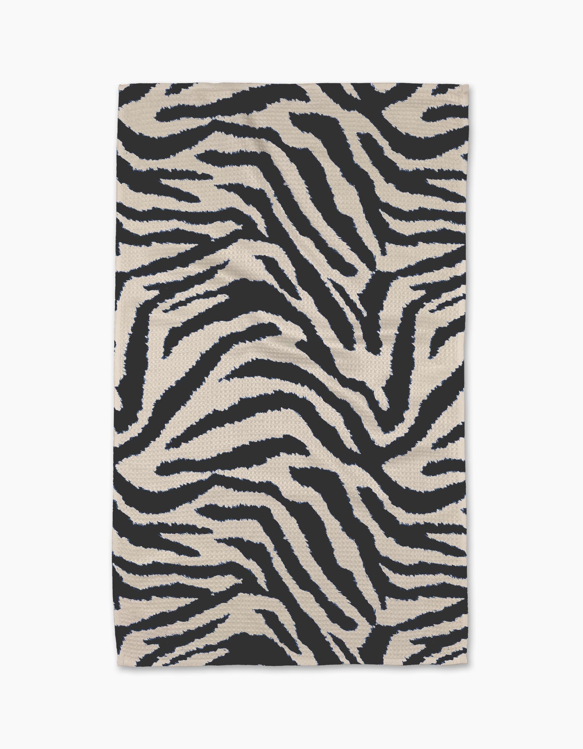 The Geometry Zira Black rug is a rectangular piece featuring bold black and white zebra stripes, crafted from recycled materials and displayed flat against a white background.