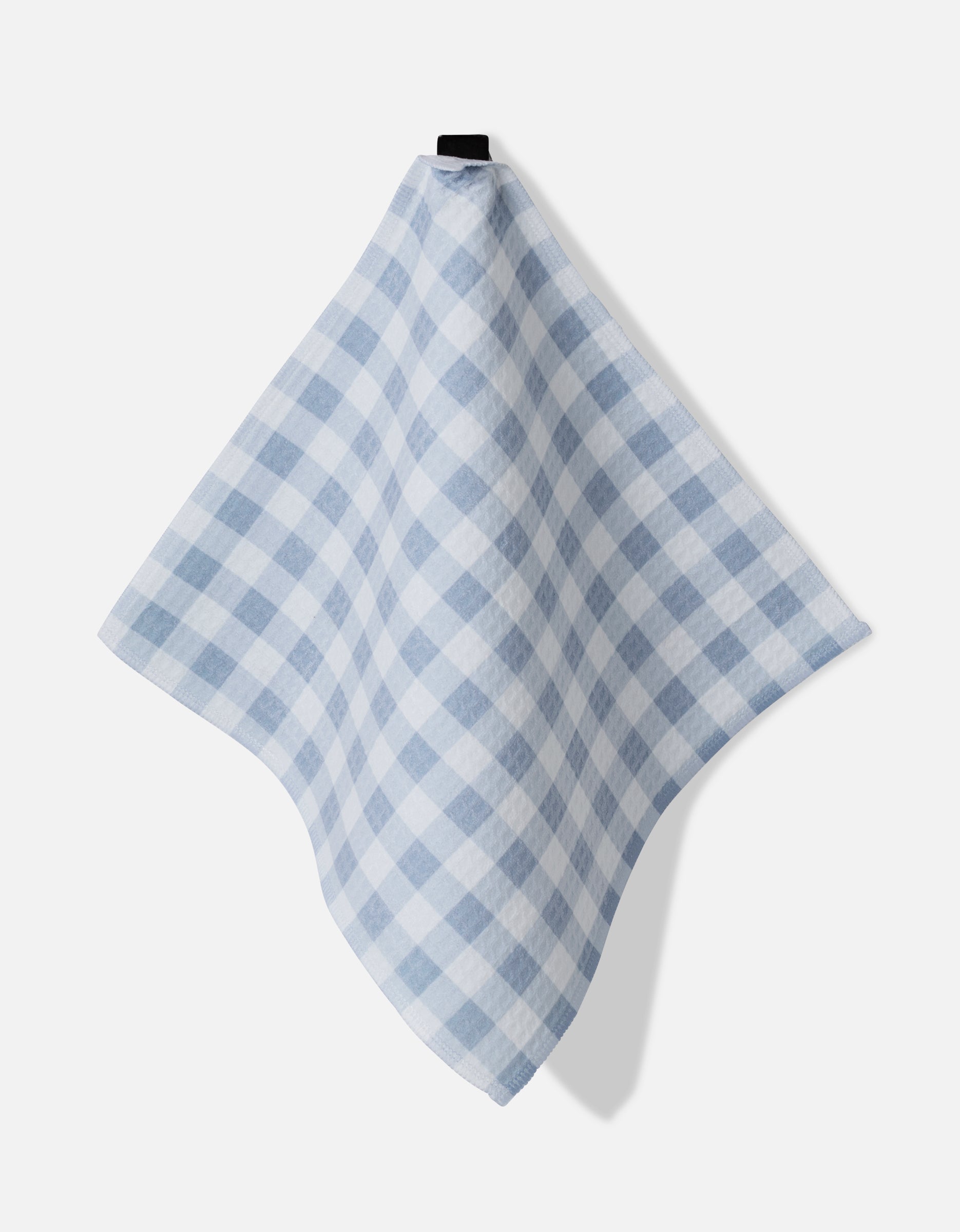 The Aubrey Fairchild Blue Gingham cloth, featuring a large blue and white checkered pattern, hangs from a black hook against a plain white background, showcasing its ultra-absorbent fabric.