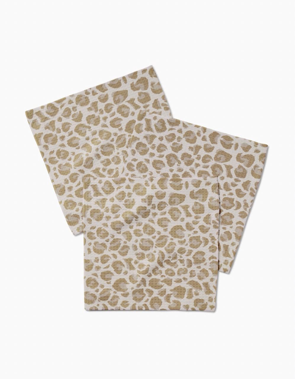 Two GEOMETRY Light Leopard washcloths, featuring a beige and white leopard print and ultra-absorbent Geoweave technology, are shown overlapping on a plain white background.